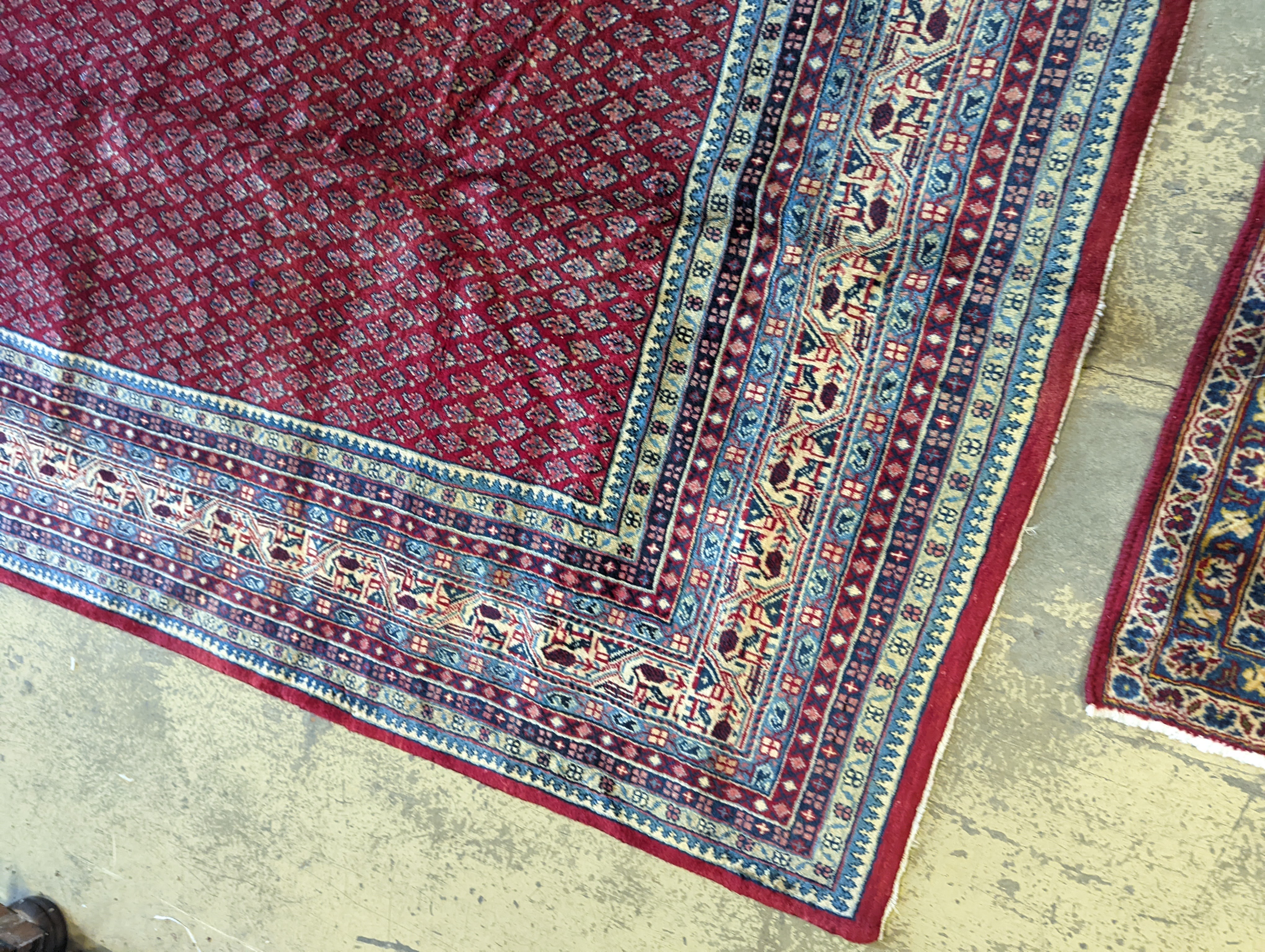 An Araak crimson ground carpet, 350 x 250cm